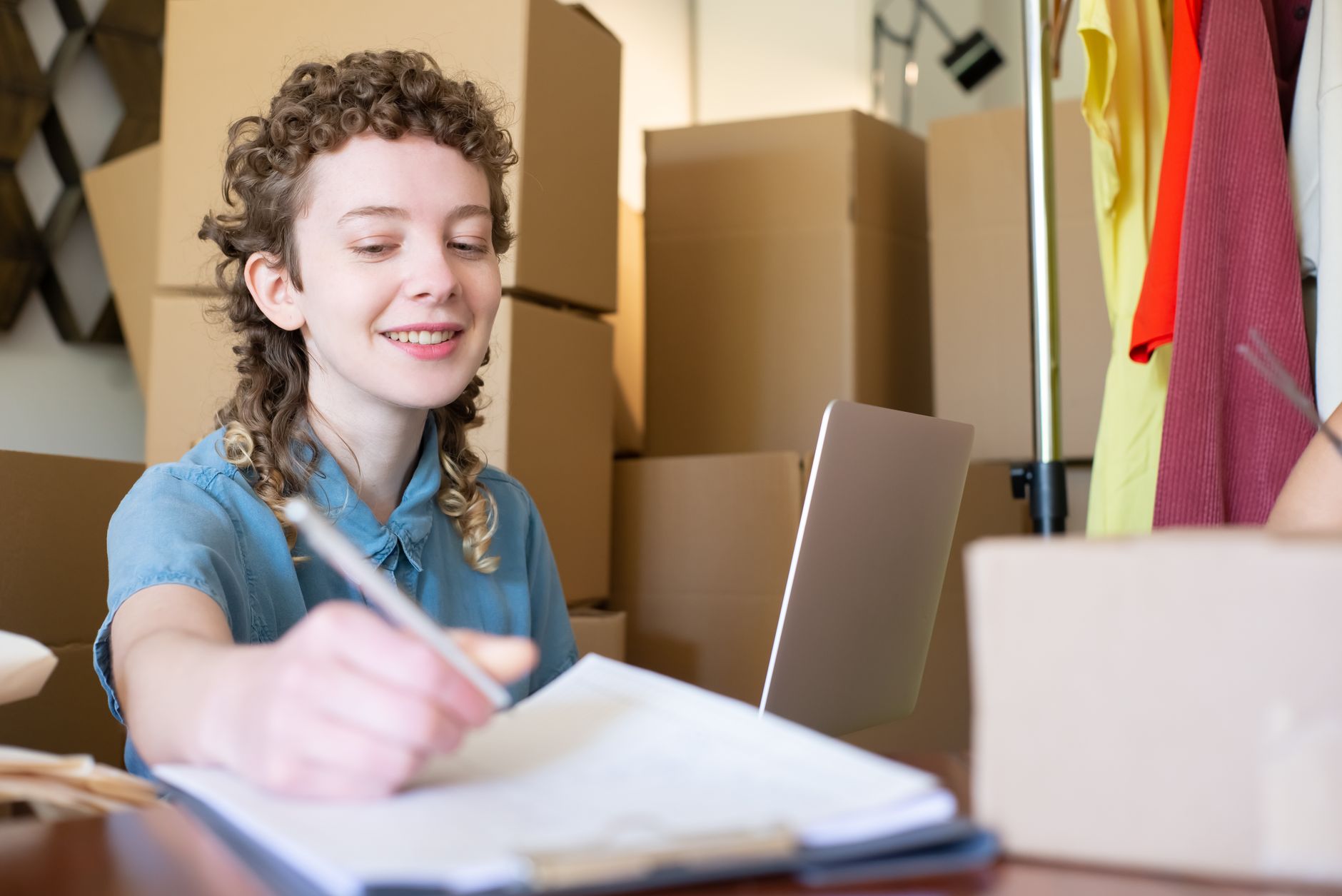 A small business owner packing orders at a desk.